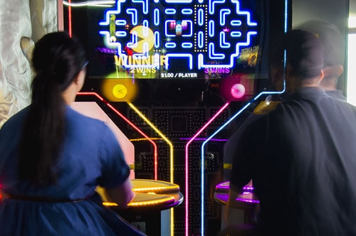 Two people on the Pacman game